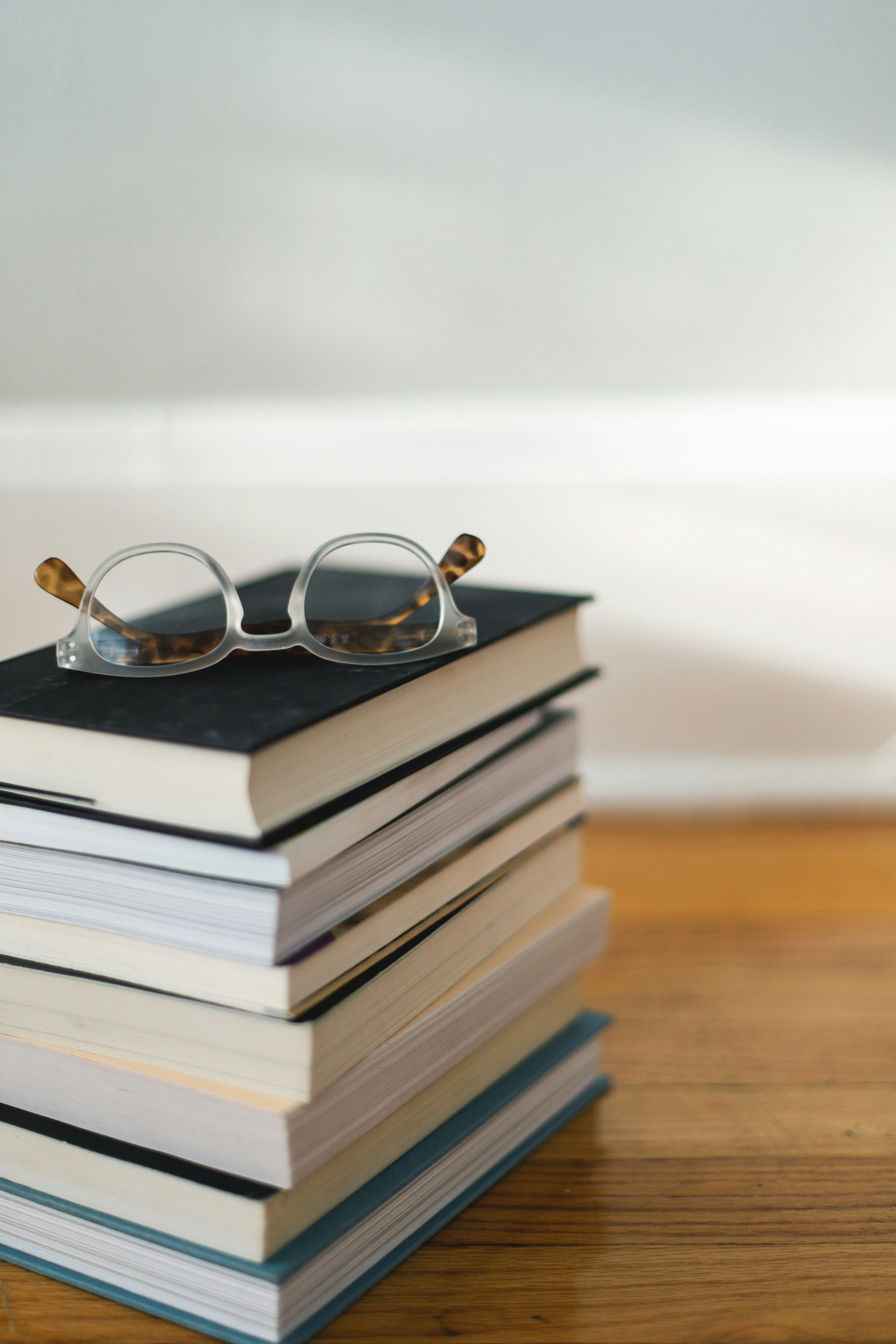 Stack of novels with eye glasses