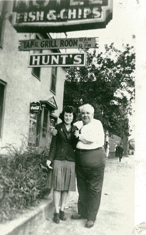 Unidentified Man and Woman in Front of Hotel